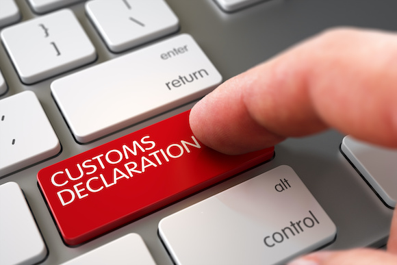 Man finger pushing customs declaration red button on keypad